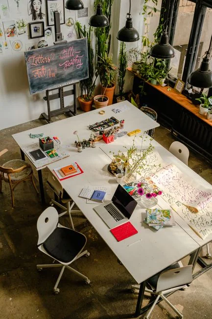 A close-up of a modern workspace, featuring a laptop and smartphone in use.